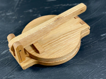 Tortilla press showing the natural white oak grain