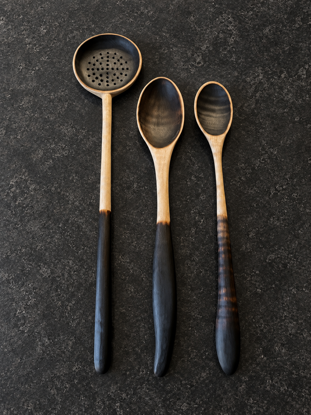 Handcrafted charred wooden kitchen utensils