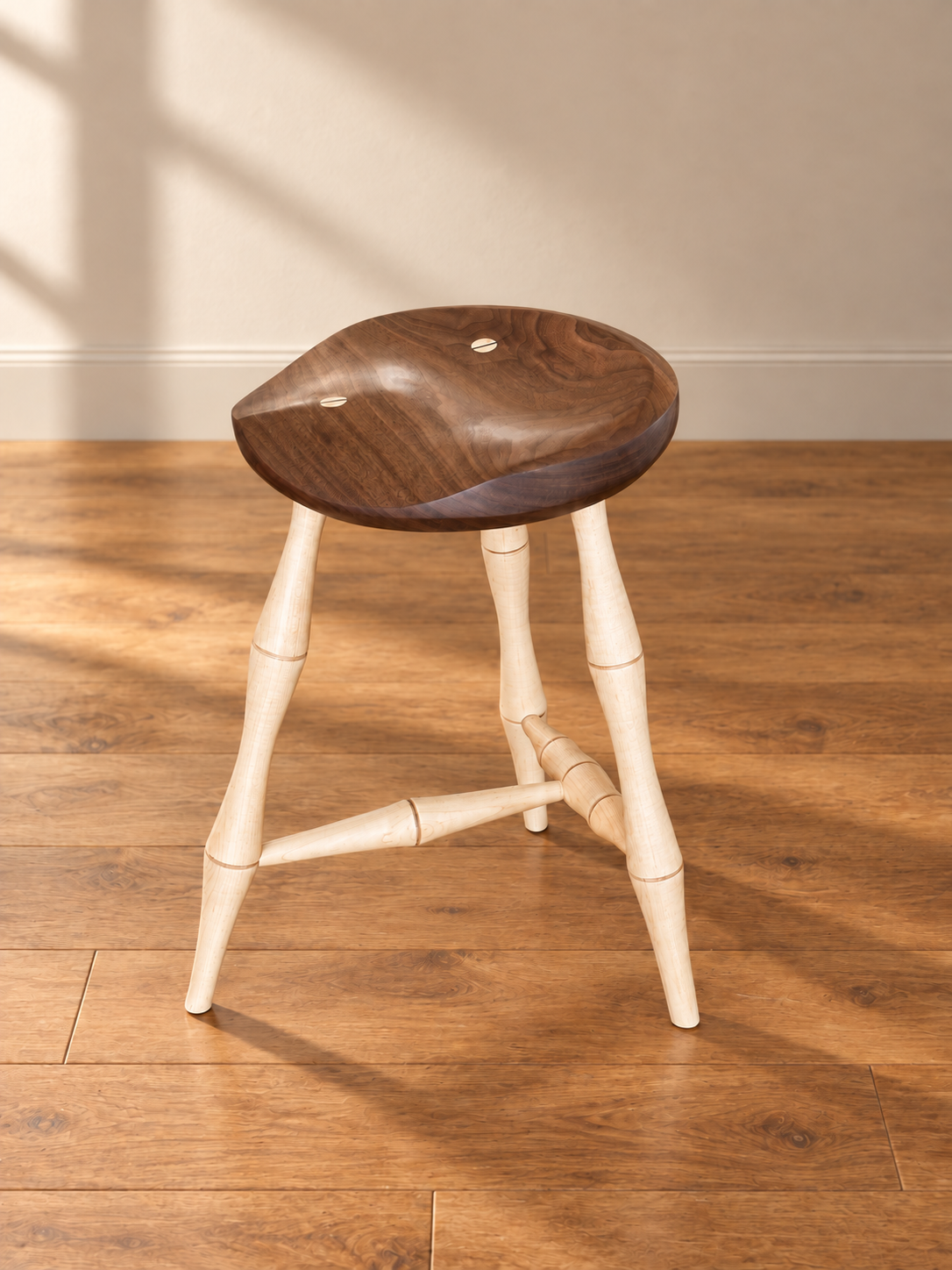 Handcrafted walnut stool with turned maple legs